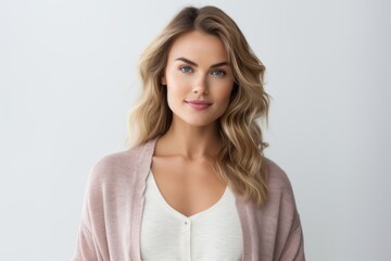 Naklejka premium Medium shot portrait of a Russian woman in her 30s in a white background wearing a chic cardigan