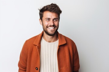 Fototapeta premium Portrait of a happy young man smiling at camera isolated over white background