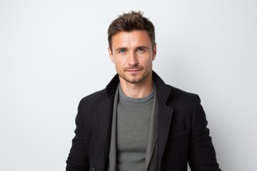 Fototapeta premium Portrait of handsome young man in black coat looking at camera.