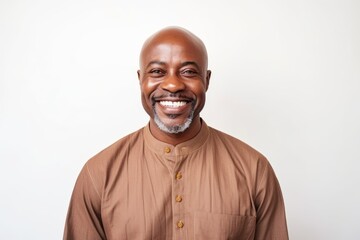 Fototapeta premium Portrait of happy african american man smiling at camera against white background