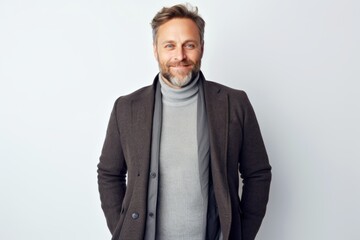 Fototapeta premium Portrait of a handsome middle-aged man in a jacket and scarf
