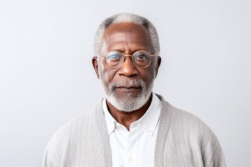 Obraz premium Medium shot portrait of a Nigerian man in his 60s in a white background wearing a chic cardigan