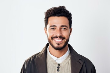 Obraz premium Portrait of a Saudi Arabian man in his 20s in a white background wearing a chic cardigan