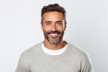 Portrait of a handsome man smiling and looking at camera over white background