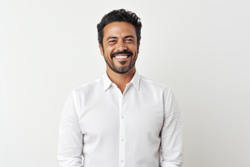 Portrait of a handsome Indian man smiling at camera over white background