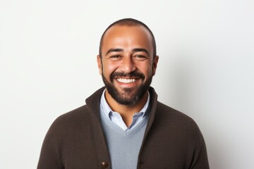 Obraz premium Portrait of a happy latin man smiling against a white background