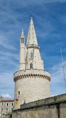 Fototapeta na wymiar Vertical shot of The tower of the old castle in La Rochelle in France under the blue sky