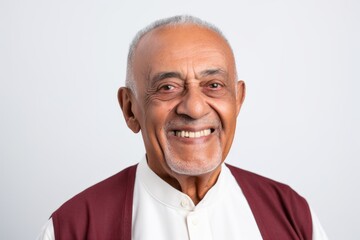 Fototapeta premium Portrait of a happy senior Indian man smiling and looking at camera