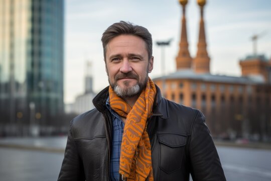 Portrait of a Russian man in his 40s in a modern architectural background wearing a foulard