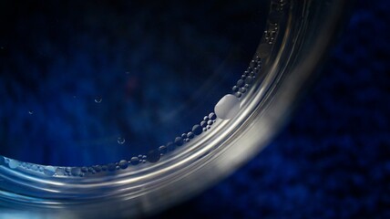Gotas de aceite sobre agua con fondo azul