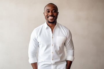 happy african american man in white shirt over grey wall background