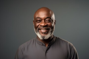 Portrait of a happy senior african american man on grey background