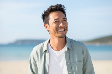 Portrait of a smiling man at the beach on a sunny day