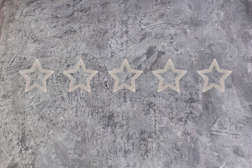  gray, silver five star shape on the gray concrete background. The best excellent business services...