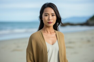 Portrait of asian woman standing on the beach at seaside