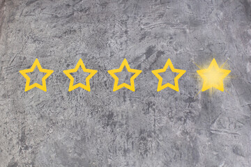Gold, gray, silver five star shape on the gray concrete background. The best excellent business...