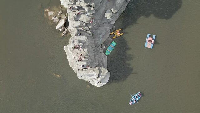 Boat trip on catamarans and boats.Stone island of Zhumbaktas in the middle of a mountain lake in Kazakhstan Borovoe.The rock in the middle of the water the Kazakh Sphinx.A lot of people on the water
