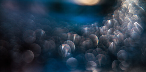 Sunny bokeh from drops on misted glass. light effect. Abstract fantasy background.