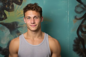 Portrait of a Russian man in his 20s in an abstract background wearing a sporty tank top