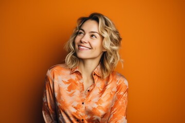 Portrait of a Russian woman in her 30s in an abstract background wearing a chic cardigan
