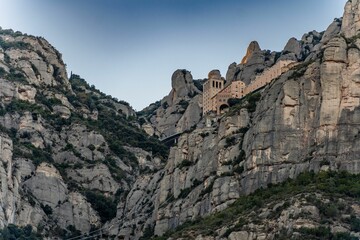 Fototapeta na wymiar Low-angle view pf the famous Basilica de Monserrat on the high cliffs in Spain