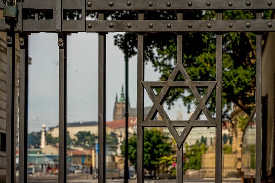 Closeup of an iron gate with a Star of David symbol on it in Prague, Czechia