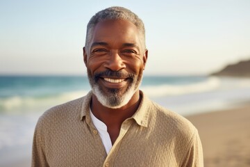 Portrait of smiling mature man standing on beach on a sunny day