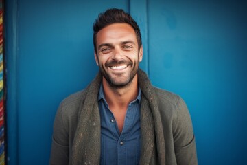 Portrait of a Brazilian man in his 30s in an abstract background wearing a chic cardigan