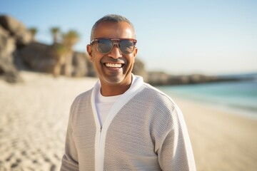 Portrait of smiling man wearing sunglasses at beach on a sunny day