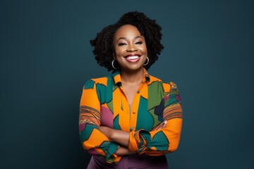 Portrait of a Nigerian woman in her 30s in an abstract background wearing a chic cardigan