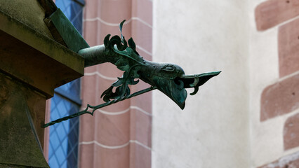 Rain chute resembling the head of a mystical animal on a church 