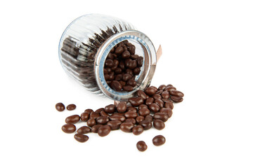 Chocolate dragee in a transparent glass jar isolated on a white .