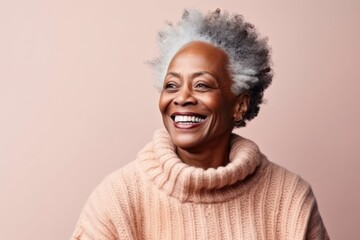 Medium shot portrait of a Nigerian woman in her 60s in an abstract background wearing a cozy sweater