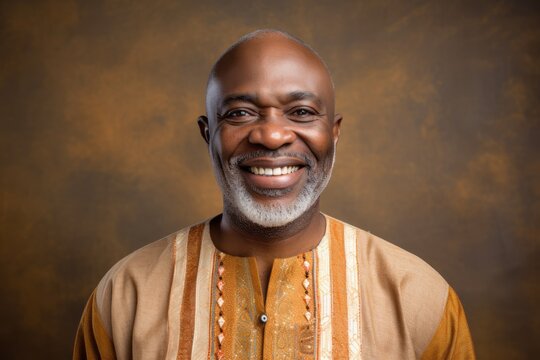 Portrait of a Nigerian man in his 50s in an abstract background wearing a simple tunic