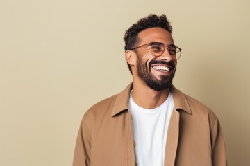 Portrait of a Saudi Arabian man in his 30s in an abstract background wearing a chic cardigan