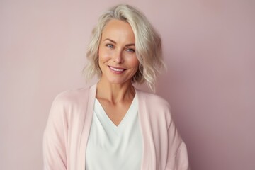 Medium shot portrait of a Russian woman in her 40s in a pastel or soft colors background wearing a chic cardigan