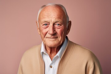 Obraz premium Portrait of a Russian man in his 80s in a pastel or soft colors background wearing a chic cardigan