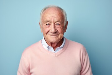 Obraz premium Portrait of a Russian man in his 90s in a pastel or soft colors background wearing a chic cardigan