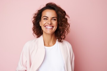 Fototapeta premium Portrait of a Brazilian woman in her 30s in a pastel or soft colors background wearing a chic cardigan