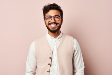 Portrait of a Saudi Arabian man in his 20s in a pastel or soft colors background wearing a chic cardigan