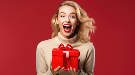 Happy smiling woman holding gift box over red background