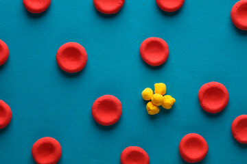 Red blood cells with lipids model made from plasticine on blue background. Cholesterol