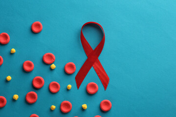 Red blood cells model with aids awareness ribbon on blue background