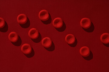 Red blood cells model on red background