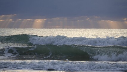 Tranquil beauty of a beach with rolling blue waves and a foamy shoreline
