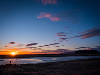 Fototapeta na wymiar Photo of a beautiful sunset over a serene Icelandic body of water