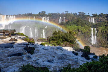 Perfect rainbow over Iguazu Waterfalls, one of the new seven natural wonders of the world in all its beauty viewed from the Brazilian side - traveling South America