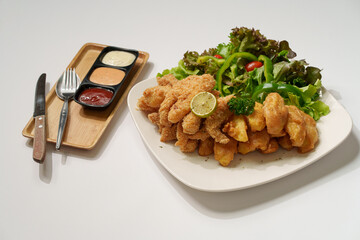 Large plate of fish and chips with salad
