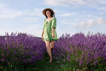 Happy woman wearing hat in lavender field