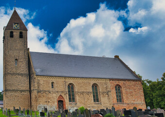 Fototapeta premium The romano-gothic 12th-century St Agatha Church in Oudega, one of the oldest churches in the province of Friesland, the Netherlands